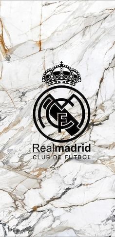 the real madrid club logo is shown on a marble wall with black and white colors