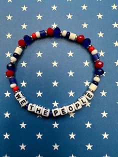 We The People glass and clay polymer beaded stretch bracelet is a stylish way to show off your patriotism!  Bracelets are available in a variety of lengths.  Pick your custom length from the drop down menu below.  Please be aware that beading may slightly differ from what is pictured as to accommodate selected sizing.  All our bracelets are made with quality in mind.  With that being said, all bracelets should be treated with care while putting on, wearing, and taking off.  Keep dry. Do not swim Patriotic Blue Beaded Stretch Bracelet, Blue Beaded Patriotic Stretch Bracelet, Patriotic Blue Stretch Bracelet For 4th Of July, Patriotic Multicolor Stretch Bracelet For 4th Of July, Patriotic Blue Beaded Bracelets, Patriotic Round Beads Stretch Bracelet For 4th Of July, Patriotic Beaded Bracelets For 4th Of July, Holiday Party Accessories, Letter Bead Bracelets