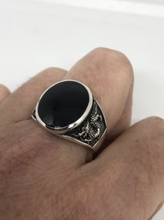 Cool Vintage Rock and Roll star men's ring Nice heavy ring, Sterling silver set with genuine black Onyx Unused stock from the 1970's I have a sizes 7.75, 9, 10.25, 10.75, 11.75, and 12.5 These can be resized by my jeweler for a $10 fee Please add your size to the order in a message and I will send the size you require. All jewelry is shipped in a nice gift box. Check out our over a THOUSAND great reviews Engraving is $4 per letter and is not always perfect depending on the piece. It can take a f Black Gothic Collectible Rings, Vintage Black Sterling Silver Signet Ring, Collectible Black Rings With Polished Finish, Vintage Black Round Signet Ring, Black Sterling Silver Signet Ring For Collectors, Mermaid Ring, Vintage Gothic, Vintage Rock, Mens Ring