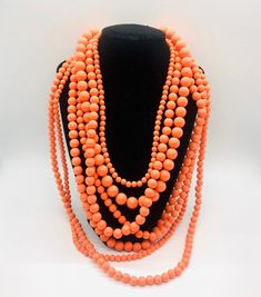 Fabulous large chunky multi strand faux coral necklace. 7 strands of Lucite beads in many different sizes and lengths. The shortest strand (closest to the neck) measures 21 inches long including extender chain and the longest strand (farthest from the neck) is 35 inches long including extender. Has secure clasp. Perfect for summer. In excellent vintage condition with minimal age appropriate wear. Coral Beads Necklace, Vintage Designer Jewelry, Necklace Layered, Coral Necklace, Plastic Resin, Coral Beads, Multi Strand Necklace, Vintage Designer, Strand Necklace