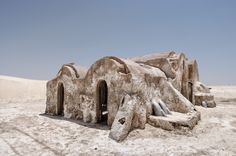 an unusual house made out of rocks in the desert