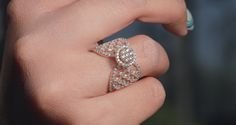 a woman's hand with a diamond ring on it