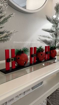 christmas decorations sit on a mantle in front of a mirror