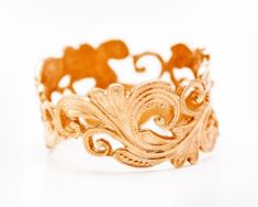 a close up of a gold ring on a white background