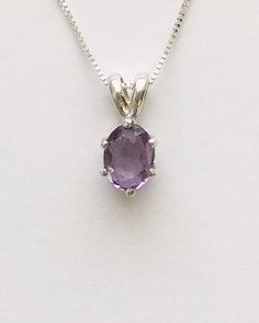 Genuine small oval amethyst measures 7x5mm (3/4 carat) and was handset in sterling silver. Sterling silver box chain is 18 inches long and can be switched out to a 16 inch chain upon request. Necklace is perfect for a child or the minimalist. Comes in a gift box Dainty Sterling Silver Oval Birthstone Necklace, Dainty Oval Sterling Silver Birthstone Necklace, Purple Birthstone Oval Pendant Jewelry, Oval Amethyst Birthstone Necklaces, Purple Oval Pendant Birthstone Jewelry, Oval Gemstone Birthstone Necklace In Sterling Silver, Oval Lavender Gemstone Necklace, Classic Oval Amethyst Necklaces, Classic Amethyst Oval Pendant Necklace