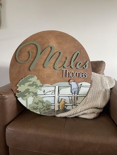 a wooden sign that says miles thomas with a photo of a man and his dog