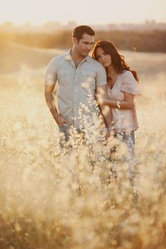 two people standing in tall grass with the caption engagement engagement photo - ideas on instagram