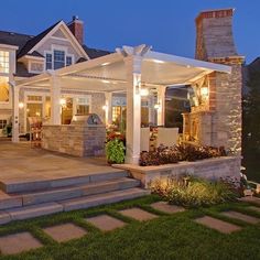 an outdoor patio with steps leading up to it and a pergolated area on the side