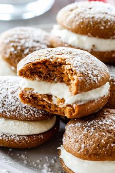 several pastries on a plate with powdered sugar and frosting in the middle