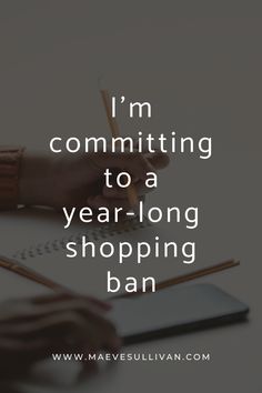 someone writing on a notebook with the words i'm committing to a year - long shopping ban