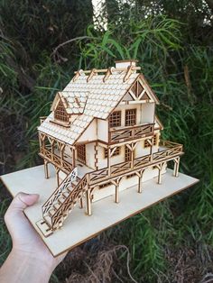 a wooden model of a house in the woods