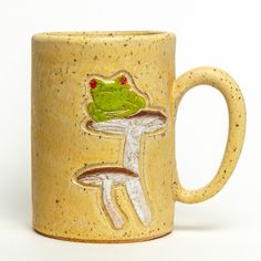 a ceramic mug with a frog on it