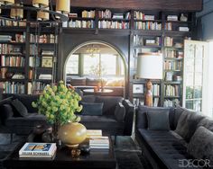 an open book showing a living room with couches and bookshelves