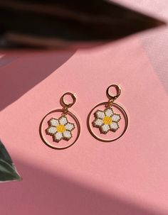 As seen on ITV’s This Morning!Beautiful, playful hoop earrings with brightly coloured daisies. The perfect feel-good earring!Hand beaded, each pair of earrings takes approximately four hours to create, and is bright, bold and fun.Choose from hot pink, sunkissed orange, traditional white, or bright yellow.I designed the FLOWERS collection to add a cheerful touch of floral feel-good energy to our day. Bright, beautiful flowers always make me smile and I wanted to create a collection of floral jewe Handmade Hoop Flower Earrings For Summer, Handmade Summer Flower Hoop Earrings, Handmade Hoop Earrings For Spring, Trendy Handmade Flower Hoop Earrings, Handmade Flower-shaped Hoop Earrings For Spring, Spring Beaded Round Earrings, Handmade Small Hoop Earrings For Spring, White Flower Earrings, Beaded Daisy