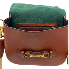 This larger full-size version of the popular Blair Midsize Bag is nothing short of stunning! It includes an interior zipper pocket within the vibrant Hunter Green suede liner of the Chestnut version and Navy suede liner of the Zucchini Green version that makes it easy to find what you are looking for. The wide leather and canvas shoulder strap has traces of gripping rubber to elevate this equestrian lovers bag. Also available for purchase is a longer shoulder/crossbody canvas strap and a 3/4" wi Cognac Saddle Bag With Leather Lining, Luxury Brown Saddle Bag With Leather Trim, Luxury Saddle Shoulder Bag With Leather Handles, Luxury Cognac Saddle Bag With Leather Lining, Cognac Saddle Bag With Removable Pouch, Designer Travel Saddle Bag, Designer Saddle Bag For Travel, Designer Saddle Bag For Everyday Use, Brown Top Handle Saddle Bag With Leather Trim