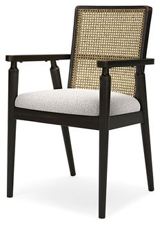 the arm chair is made from wood and has an upholstered fabric seat pad