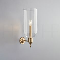 a light that is on the wall with a candle in it and some lights attached to it