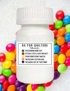 a bottle of rx for quilters on top of some candy balls in the background