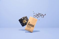 a bag with seeds coming out of it and falling into the air on a blue background