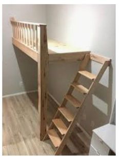 there is a wooden staircase next to the bed