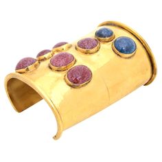 This theatrical and dramatic vintage Mary McFadden very wide cuff bracelet has lapis lazuli and another burgundy agate stone against the gold brass. It is signed Mary McFadden Hand Crafted. It envelopes a time of Egyptian revival meets modern. This needs a long arm and a woman who is loves dramatic statements and dramatic jewelry. The cuff is very wide in size on your arm or wrist. It is 4.25" W or long on your wrist. The opening on the back side is almost 2". This was done in the 70's when Mary Dramatic Jewelry, Gold Cuff Bracelets, Yellow Gold Cuff Bracelet, Mary Mcfadden, Sculpted Jewelry, Bracelet Cuffs, Stone Bangles, Vintage Meets Modern, Vintage Cuff Bracelet