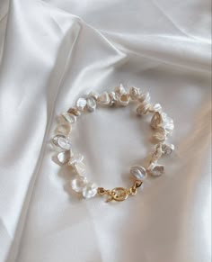 This Keshi Pearl bracelet/Cornflake pearl bracelet/White pearl bracelet/Pearl bracelet with toggle/Gift for her/Mother's day gift is made with Keshi pearls on a toggle closure. Keshi pearls are small non-nucleated pearls typically formed as by-products of pearl cultivation. Each pearl has its unique shape and beautiful high luster. The bracelet is customized based on the wrist size. The one shown in the picture is approximately 7.5 inches long. This will be a wonderful and special gift for yours Feminine Pearl Bracelet Gift, Feminine Pearl Bracelet For Gift, Baroque Pearl White Pearl Bracelet For Jewelry Making, Baroque Pearl Bracelet With Pearl Drop In Pearl White, Pearl White Baroque Pearl Bracelet With Pearl Drop, Dainty Baroque Pearl Bracelet Gift, Baroque Pearl Bracelet With Pearl Charm As Gift, White Baroque Pearl Bracelets As Gift, Pearl Charm Mother Of Pearl Bracelets As Gift