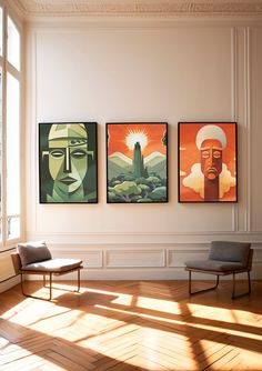 three paintings hang on the wall above a chair in an empty room with wooden floors