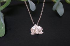 -Product description- Beautiful sterling silver orchid flower necklace. Orchid petals are matt finish with engraved patterns, while the core is shimmery as a contrast. The edges of the petal are burnished, adding more sparkles to the whole piece. A beautiful Singapore chain was used, forming a beautiful flow with the orchid. Great as a gift for her, or a treat for yourself. The chain measures 20 inches. The orchid is about 18mm (11/16 inch) in diameter. Please feel free to contact me with any cu Elegant Engraved Flower Necklace, Orchid Necklace, Floral Pendant, Floral Necklace, Orchid Flower, Floral Earrings, Flower Necklace, Sterling Silver Necklace, Sterling Silver Necklaces