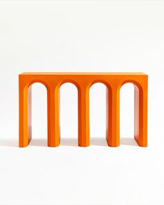 an orange table sitting on top of a white floor