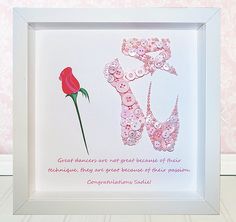 a framed paper art with a red rose