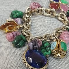 Pre-Owned Unique Multicolor Charms Jewelry, Unique Multicolor Jewelry With Charms, Unique Multicolor Charm Jewelry, Luxury Multicolor Jeweled Bracelets, Elegant Vintage Charm Bracelets For Jewelry Making, Elegant Metal Charm Bracelet Collectible, Elegant Metal Charm Bracelet For Collectors, Vintage Multicolor Oval Jewelry, Luxury Multicolor Bracelet Jewelry