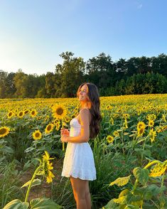 a woman standing in a field of sunflowers