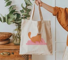 A 100% cotton tote bag is the champion of durability, sustainability, and style. .: Material: 6 oz/yd², 100% natural cotton canvas fabric .: One size: 15" x 16" (38.1cm x 40.6cm) .: Convenient self-fabric handles .: Double-sided print Casual Cotton Bag With Cat Print, Rectangular Cotton Bag With Cat Design, Cotton Bag With Cat Print, Rectangular Shape, Rectangular Cotton Bag With Cat Print, Cotton Cat Print Rectangular Bag, Daily Use Cotton Bags With Cat Design, Cotton Tote Bag With Cat Design, Cotton Bags With Cat Print For Everyday Use, Everyday Cotton Bags With Cat Print