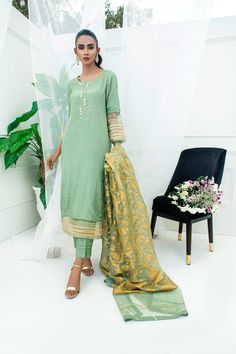 Festive Raw Silk Lawn Suit With Traditional Drape, Traditional Chinon Lawn Suit With Resham Embroidery, Semi-stitched Raw Silk Kurta With Dabka Work, Festive Designer Raw Silk Lawn Suit, Festive Raw Silk Lawn Suit With Zari Work, Designer Raw Silk Lawn Suit For Eid, Designer Raw Silk Lawn Suit With Resham Embroidery, Unstitched Raw Silk Traditional Wear For Eid, Designer Gold Raw Silk Lawn Suit