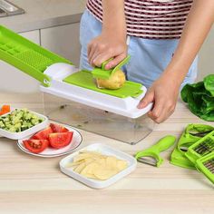 a person cutting vegetables with a green vegetable slicer