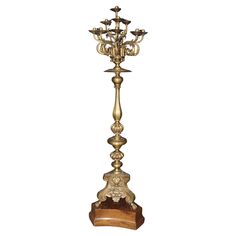 an ornate golden candelabra with candlesticks on the top and bottom