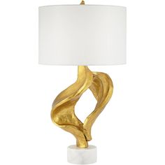 a gold table lamp with a white shade on it's base and an abstract design