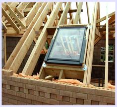 an image of a house being built with wooden framing