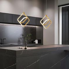 a modern kitchen with marble counter tops and gold pendant lights hanging from the ceiling above it