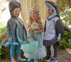 three children dressed in costumes standing next to each other