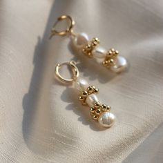 "The Baroque Eyelet Mini Hoop Earrings feature a mini hoop that hugs the earlobe and a genuine baroque pearl dangle with gold or silver signature clustering. They are perfect for everyday wear! Lightweight and comfortable to wear. Wear them two ways - slide the dangle off to wear just the simple hoop earring. \"BAROQUE EYELET MINI HOOP EARRINGS\" by GoldenLinings - Christine Elizabeth Jewelry D E T A I L S Materials: 14K Gold Fill or Sterling Silver Closure: latch hook S I Z E S Measures appox. Gold Pearl Drop Cartilage Earrings, Pearl Huggie Earrings For Anniversary, Elegant 14k Gold Filled Huggie Cartilage Earrings, Pearl Huggie Jewelry For Anniversary, Huggie Pearl Charm Jewelry For Anniversary, Yellow Gold Pearl Huggie Jewelry, Pearl Charm Huggie Jewelry For Anniversary, Anniversary Huggie Jewelry With Pearl Charm, Gold Pearl Small Hoop Earrings