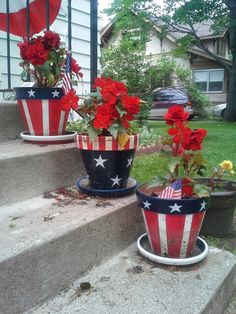 three patriotic flower pots sitting on the steps