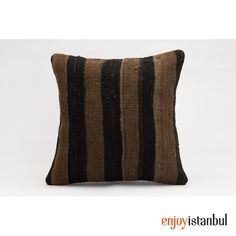 a black and brown striped pillow on a white background