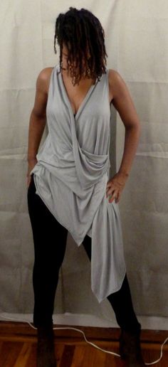 Size S,M,LGray drape top is one of my new tops.    You can wear a sports bra under,bikini top,tank top.  If you would like the arm hole smaller, please let me know.  I love draping tops, because they are stylish for any age,funky,chic and fun to wear.  You can wear leggings,skinny jeans or over any plain dress or skirt.  The fabric in the picture is rayon Lycra (light weight).  I can also make it in ity jersey which is wrinkle free and easy to care for.  Every piece of clothing in my shop is mad Chic Tops With Built-in Bra For Layering, Chic Sleeveless Top With Built-in Bra, Gray Stretch Tops For Summer, Drapey Asymmetrical Summer Tops, Versatile Fitted Draped Top, Versatile Draped Summer Top, Drapey Party Top, Fitted Sleeveless Tops For Loungewear, Stretch Summer Blouse In Gray