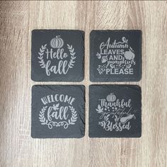 four slate coasters with autumn sayings on them