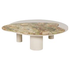 an oval table with two white pedestals on each side and a multicolored marble top