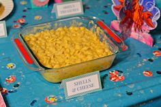 there is a bowl of macaroni and cheese on the table with other items