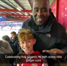 a man holding a young boy in his arms at a soccer game with the caption celebrating this gigantic ww - some little ginger run