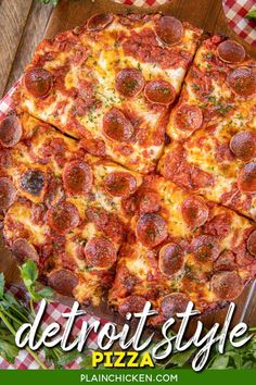 a pepperoni pizza cut into four slices on top of a checkered table cloth