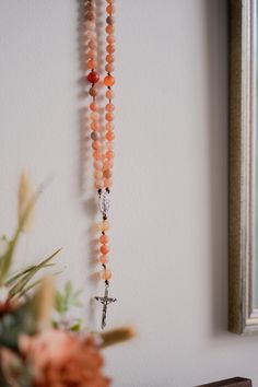 “It is love alone that gives worth to all things.” // Saint Teresa of Avila Introducing handcrafted Rosaries, prayerfully created by Blessed is She and inspired by great Saints. Carefully designed to be durable and beautiful, we’re honored to bring this prayer tool into your hands. This Rosary, inspired by Saint Teresa of Avila, features fiery, multicolored oranges and reds inspired by her passion for Jesus. Each bead of this Rosary is meticulously crafted from high-quality matte stones, creatin